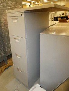 4 drawer file cabinet with a piece of desktop screwed to the top and a 2 door cabinet