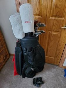 Golf Club Set, Wilson head covers, Feather Lite Irons, and 1 wood, golf bag and more