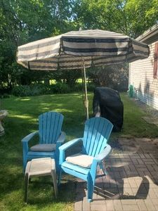 2 Plastic Adirondack Chairs with umbrella and standTable