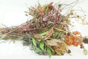 large artificial floral arrangement in tote with no lid