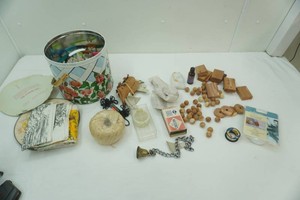 craft supplies including cedar wood pieces, twine string, leather pieces, and paint tudes