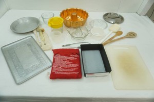kitchen supplies including bakeware, measuring cups, juicers, cutting board and more