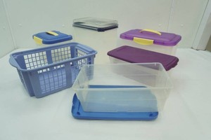 group of storage containers all but 1 with a lid, 1 basket