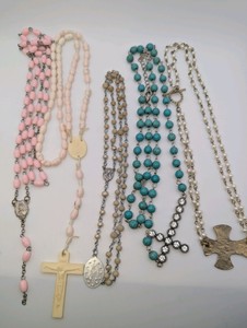 Vintage and modern religious-themed beaded necklacesrosary