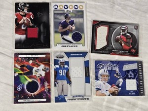 Lot of 6 Football Cards Featuring Matt Ryan, Joe Flacco, A.J. Brown, Ndamukong Suh, Jameis Winston, and Troy Aikman. Includes features like Rookie, Player-Worn Memorabilia, and numbered editions.