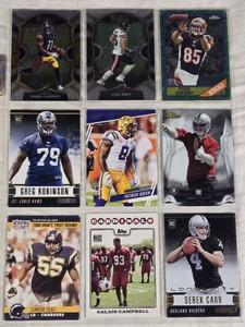Lot of 9 Football Cards Featuring Derek Carr Rookie, Junior Seau, Calais Campbell, Patrick Queen, Greg Robinson, Tyler Eifert, Cole Kmet, and Chase Claypool