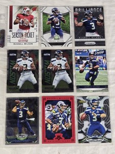Lot of 9 Russell Wilson Football Cards featuring brands like Panini and Topps. Includes cards with special features such as Brilliance, Prestige, and Finest.
