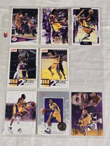 Lot of 7 Kobe Bryant Basketball Cards and 1 Stephon Marbury Card Featuring Upper Deck, Victory, and Fleer Sets.
