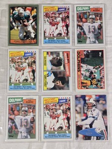 Lot of 9 Dan Marino Football Cards featuring Record Breaker cards, Passing Leaders, and Miami Dolphins highlights.