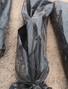 LARGE PLASTIC BAG FULL OF FABRIC ROLLS