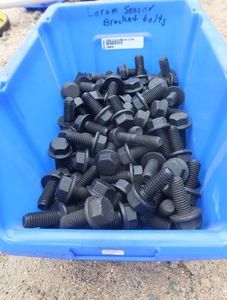 BLUE BIN FULL OF LARGE SENSOR BRACKET BOLTS