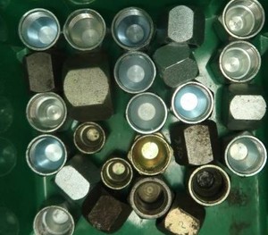 ASSORTED JIC CAPS IN GREEN PLASTIC CONTAINER