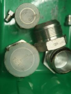 ASSORTED JIC PLUGS IN GREEN PLASTIC CONTAINER