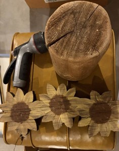 Rustic Wood Sunflower Wall Decor & Garden Hose Nozzle & Yellow Leather Ottoman