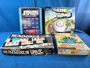 A collection of four board games Jeopardy, Game of LifeTrouble mashup, Rummikub, and Gen Z vs. The World.