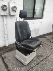 This is likely a Knoedler Air Chief Low Rider seat, identifiable by its air suspension base and adjustable headrest.