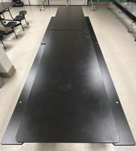 Black collapsible table on wheels with bench seating
