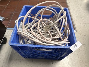 Assortment of extension cords and surge protectors with blue Crate