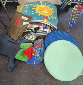 Special education supplies including Tuk N Kari sling, weighted mat, floor seats, and floor carpets