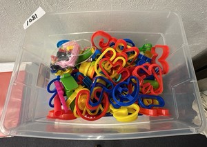 Plastic container with Play-Doh, accessories, and mini toy construction trucks