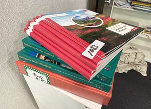 CoreKnowledge kindergarten teacher handbook x3, plus AmplifyCKLA activity book volume 2, and knowledge 9 seasons and weather activity book.