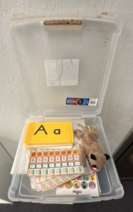 Lot container of teachers stickers, alphabet flashcards, and beanie baby