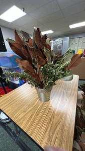 Lot of dried plants in farmhouse-style metal pot with rocks