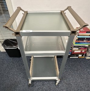 Silver and brown metal and glass cart on wheels