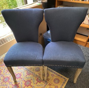 Set of 2 blue chairs with nailhead backs and gray wood legs.