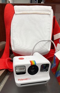 polaroid girl camera with bag six packs of film and seven battery candles