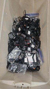 lot of broken walkie talkies bases and walkie-talkie accessories