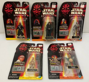 Vintage nineteen nineties Star Wars episode one action figures with comm tech chip new old stock on card.
