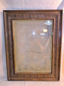 Medium sized wooden frame with glass and hanger in back