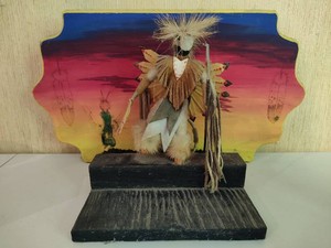 Rosebud Sioux Doll Sculpture on Painted Background