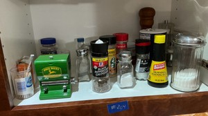 Misc kitchen spices, salt and pepper shakers, John Deere toothpick dispenser