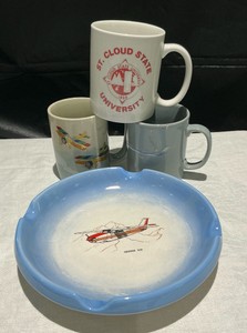 Coffee mugs, St. Cloud state, airlines and a Cessna ash tray