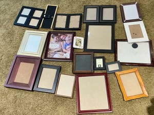 Group of Black and Brown Wood Faux Wood desk and Wall picture frames