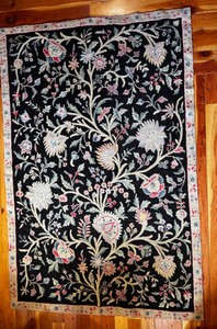 Handmade chain stich rug with black floral design inspired by European styles