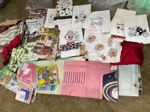 Group of various linens, embroidered hand towels, terry cloth towels, paper napkins, shower curtain