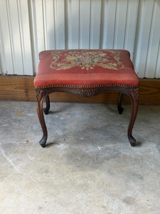 vintage French Provincial style footstool featuring a hand-stitched floral needlepoint tapestry top.