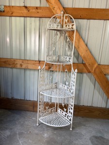 4-tier wrought iron folding corner shelf unit, commonly utilized as an indoor or outdoor corner bakers rack or plant stand.