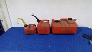 2 plastic gas cans and 1 boat tank