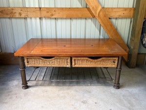 vintage style mixed-material entryway console table or vanity unit featuring a solid wood tabletop, woven wicker basket drawers, and a dark wrought iron frame.