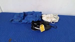 Niki 1010 Fuego cleats and a pair of white Niki cleats and sports bag
