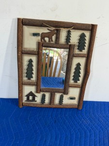 Adirondack-style rustic twig mirror, characterized by its handcrafted folk art design featuring natural wood branches and woodland motifs