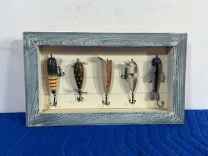 vintage-style shadow box wall decor piece containing five replica antique fishing lures. This specific rustic frame design is frequently used for cabincore, lakehouse, or man cave styling