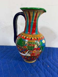 vintage Mexican folk art ceramic pitcher (often styled as a Talavera or Brunido terracotta vase). It features a hand-painted festival or village procession scene typical of mid-to-late 20th-century Mexican pottery