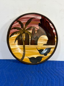 vintage hand-painted Mexican terracotta folk art plate depicting a tropical coastal sunset.