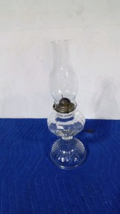 vintage pressed glass oil lamp featuring a flared base, standard chimney and a brass burner