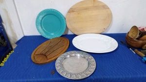 Italy white platter with grape pattern, metal tray with rams all around and a green ceramic serving tray and wooden carving boards